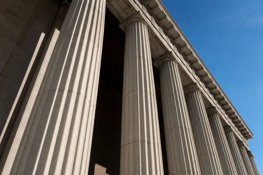 Stone colonnade seen from below, abstract architectural detail
