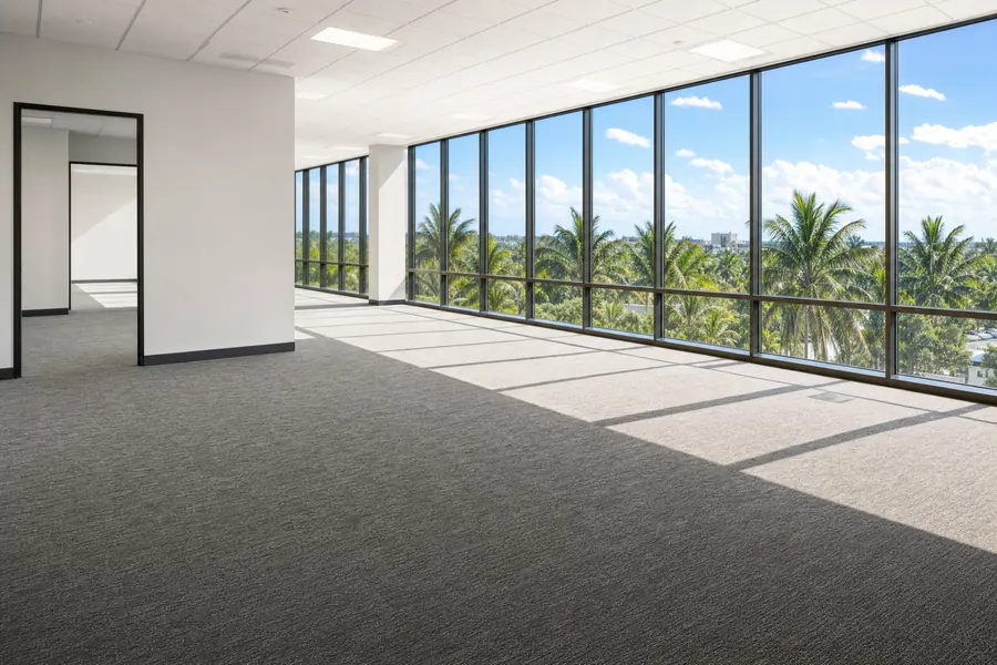 Empty office suite interior with windows to palms