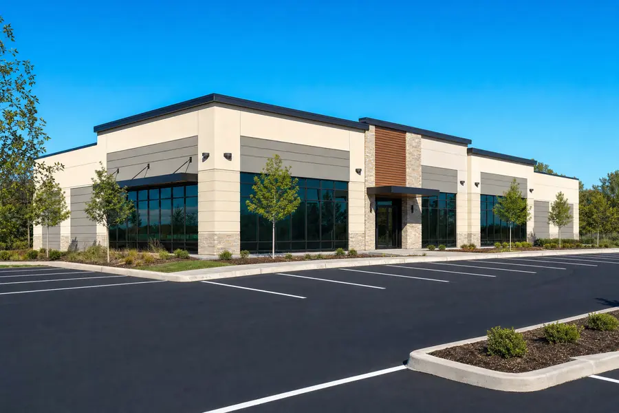 Vacant single-story commercial building with an empty parking lot