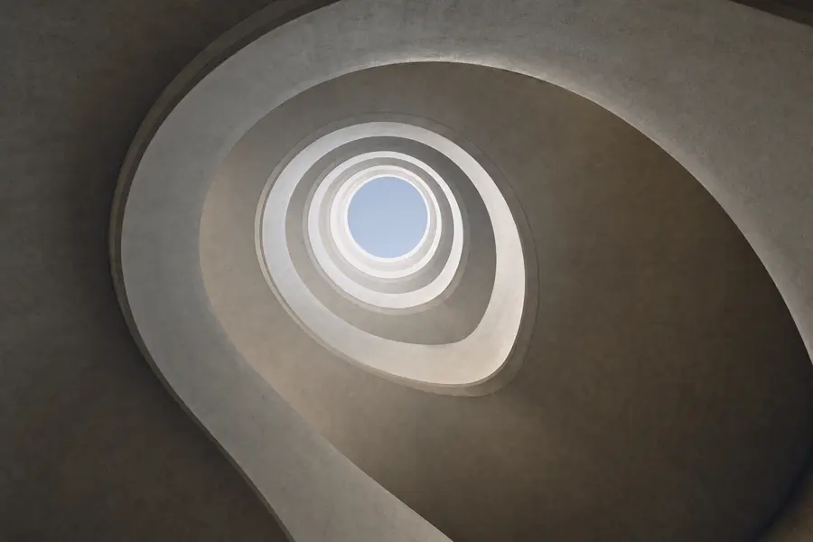 Spiral concrete parking ramp seen from below, abstract architectural detail