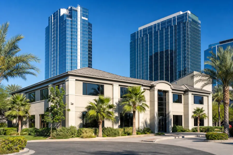 Small owner-user office building with Miami towers behind it