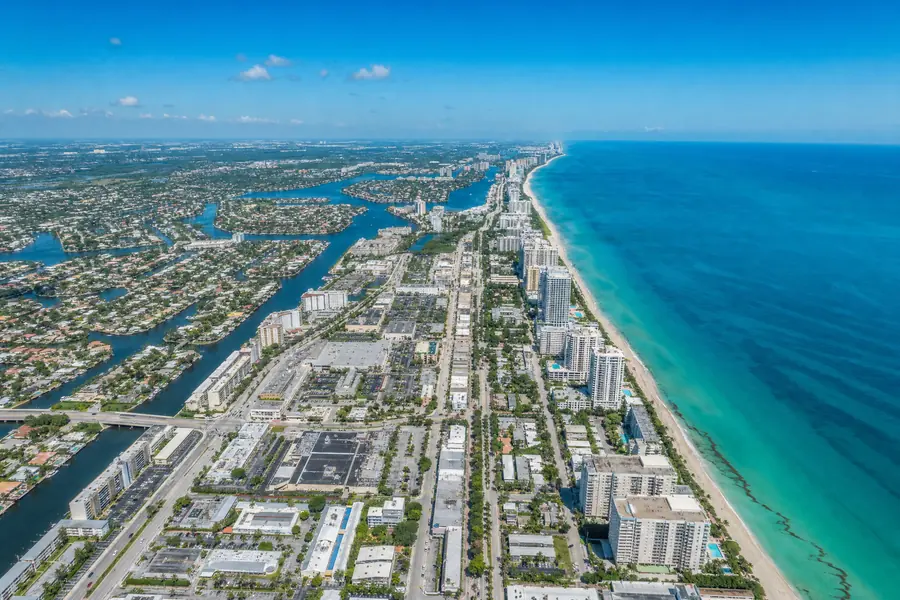 High aerial view of the South Florida coastline and commercial rooftops