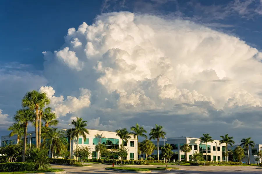Afternoon thunderhead over a South Florida commercial skyline