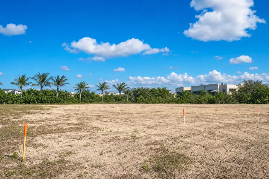 Vacant cleared development parcel with survey stakes in South Florida