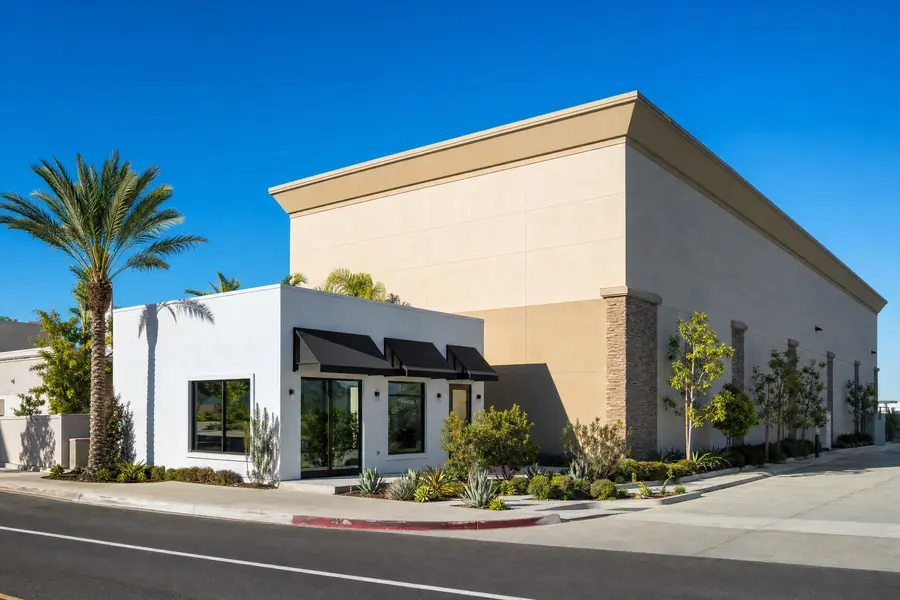 A very small commercial building beside a much larger one